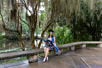 baduffy-260426-Tea's Grad Pics-7053-seated near water with cap and sash